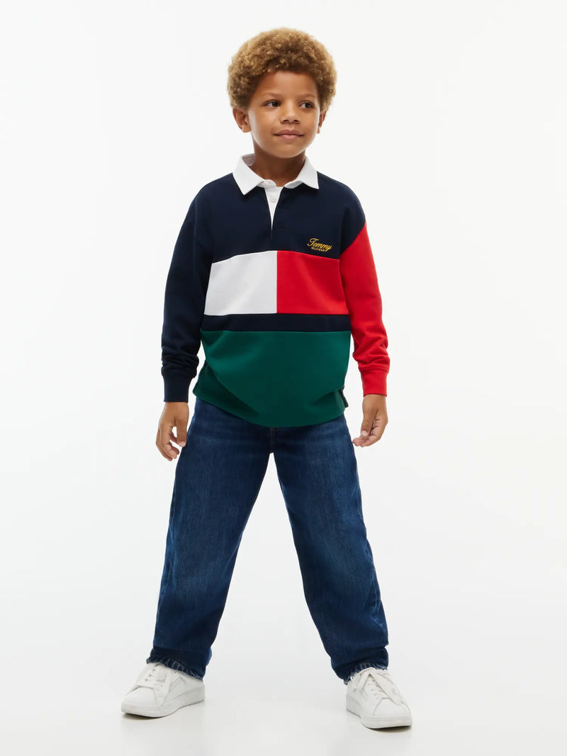 Boy modelling the Tommy Hilfiger colourblock rugby shirt.