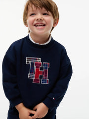 Smiling Boy modelling the Tommy Hilfiger crest tracksuit.