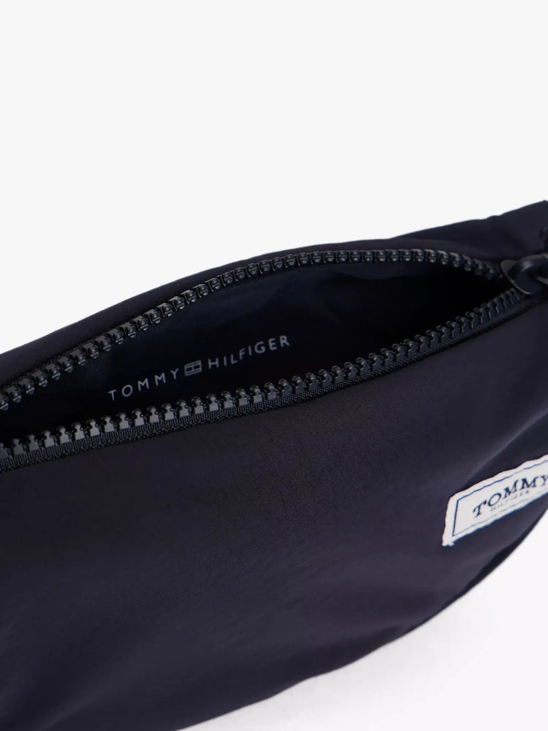 Closer view of the Tommy Hilfiger crossbody moon bag.
