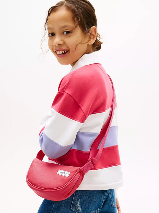 Girl modelling the Tommy Hilfiger crossbody moon bag.
