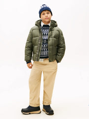 Boy modelling the Tommy Hilfiger embossed coat.