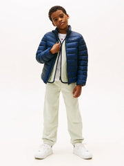 Boy modelling the Tommy Hilfiger essential down jacket.