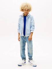 Boy modelling the Tommy Hilfiger essential jacket.