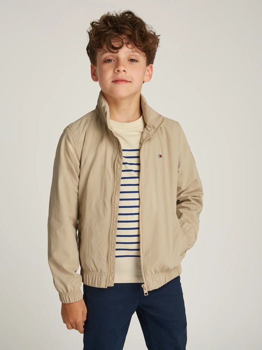 Boy modelling the Tommy Hilfiger essential jacket.