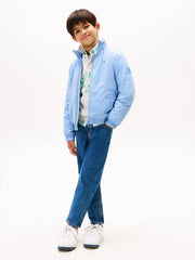 Boy modelling the Tommy Hilfiger essential jacket.