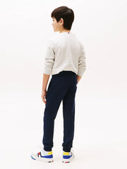 Back of the Tommy Hilfiger navy flag logo track bottoms.