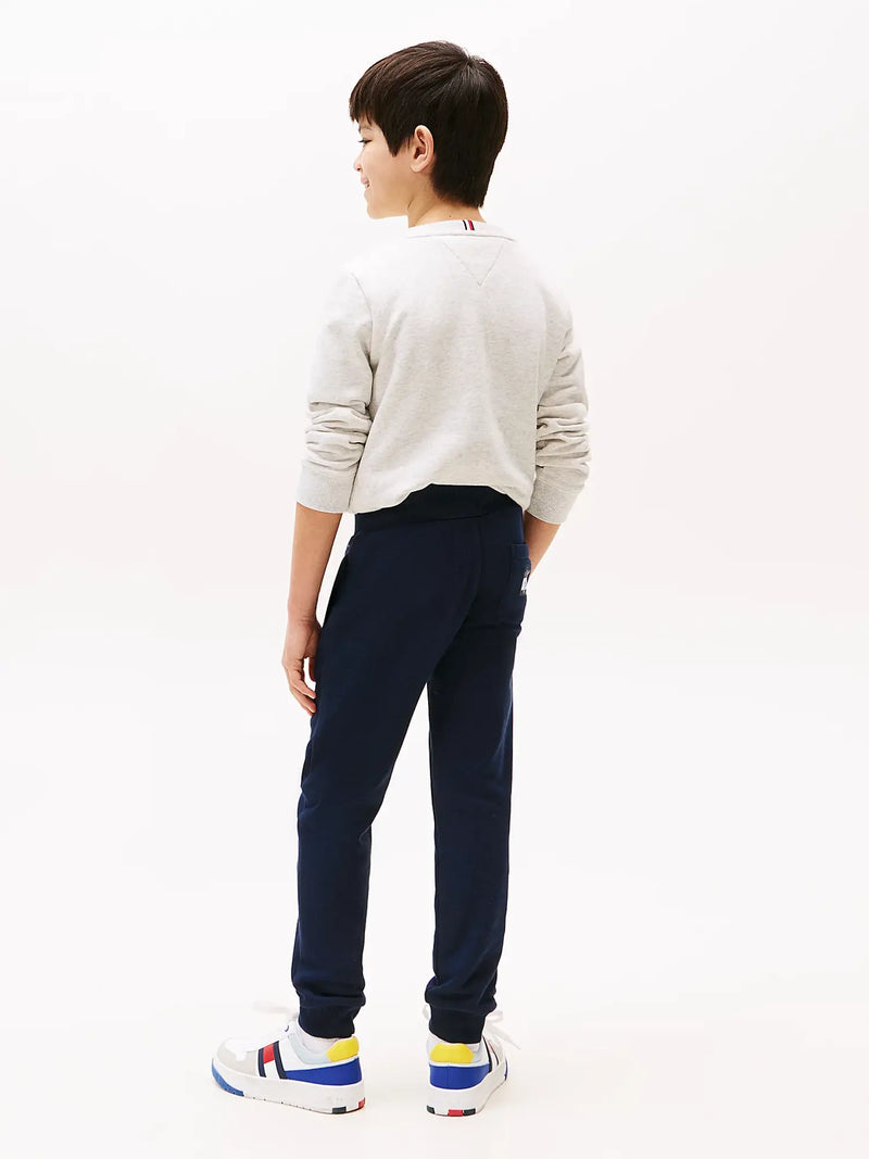 Back of the Tommy Hilfiger navy flag logo track bottoms.