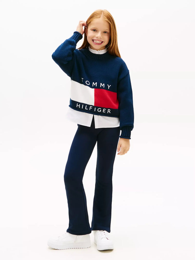 Girl in navy flared leggings by Tommy Hilfiger.