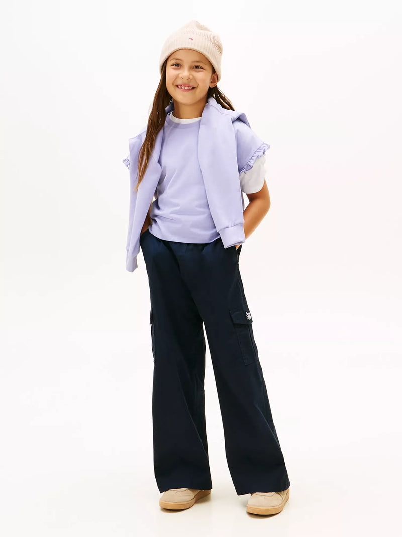 Girl in purple frilled sleeve t-shirt by Tommy Hilfiger.