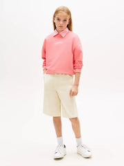 Girl modelling the Tommy Hilfiger glitter logo sweatshirt.