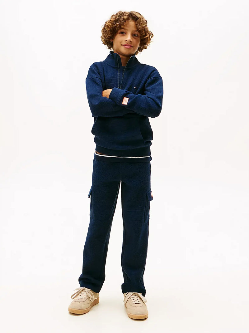 Boy wearing the Tommy Hilfiger half zip sweatshirt.