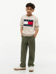 Boy in beige heritage flag sweatshirt by Tommy Hilfiger.