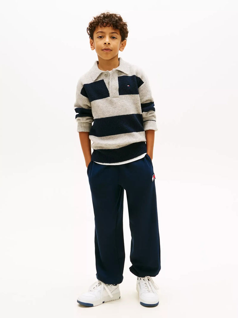 Boy modelling the Tommy Hilfiger heritage flag track bottoms.