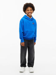 Boy modelling the Tommy Hilfiger heritage flag hoodie.