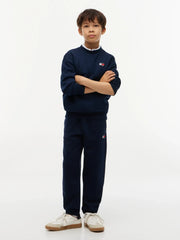 Boy modelling the Tommy Hilfiger heritage track bottoms.