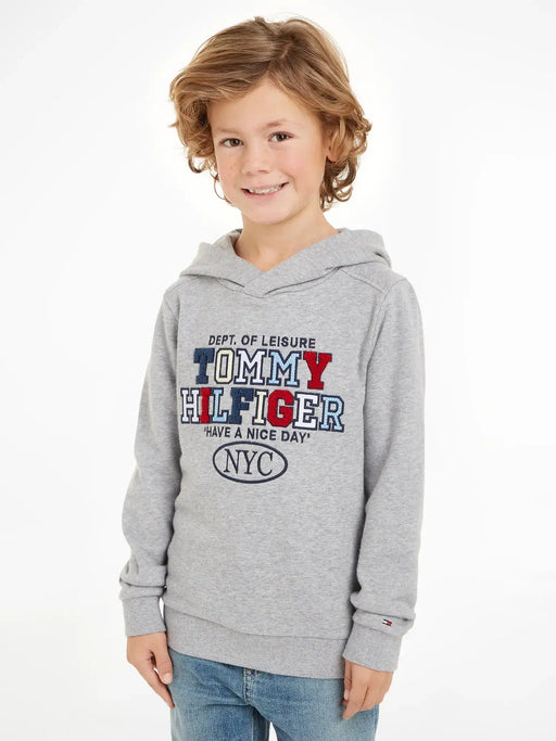 Boy wearing the Tommy Hilfiger nyc logo hoodie.