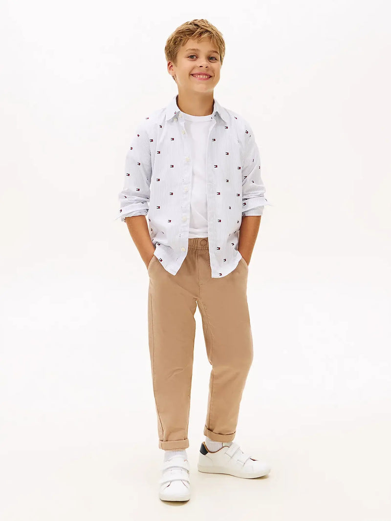 Boy modelling the Tommy Hilfiger ithaca flag shirt.