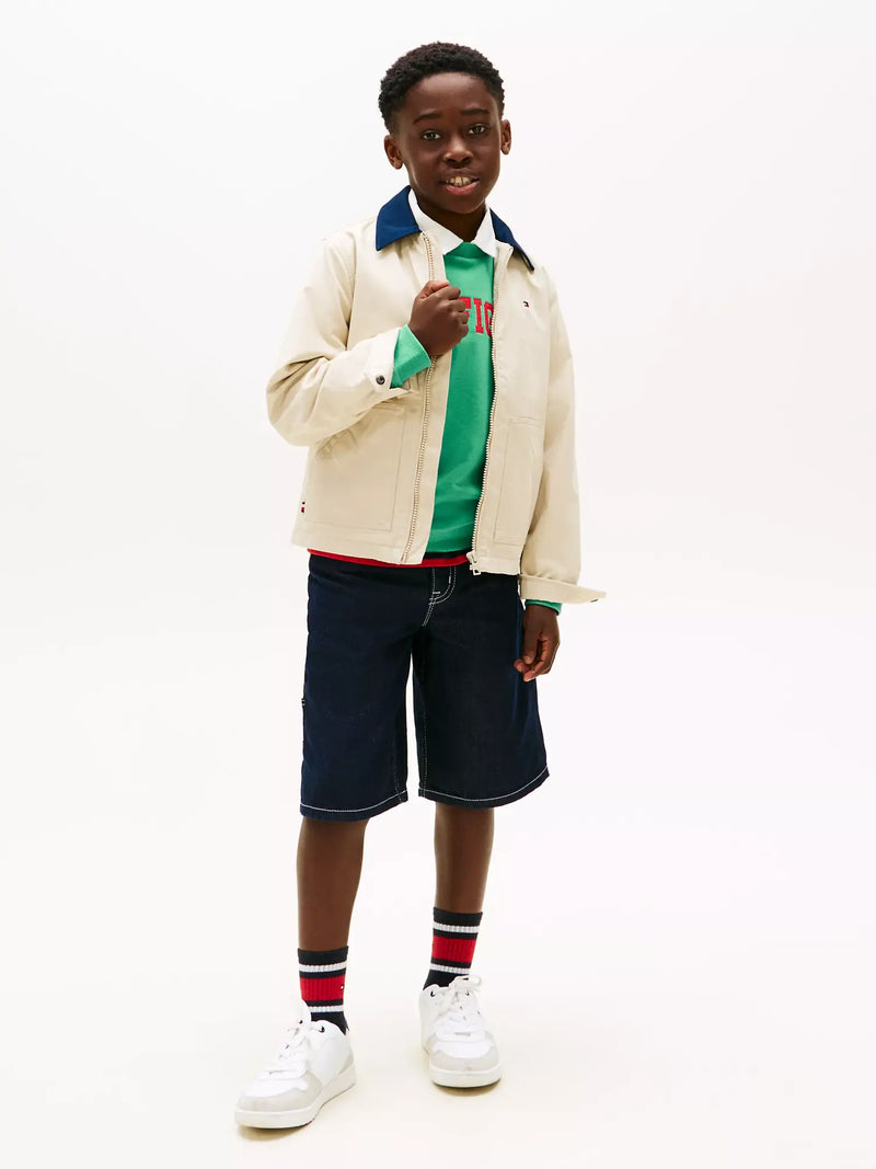 Boy modelling the Tommy Hilfiger contrast collar jacket.