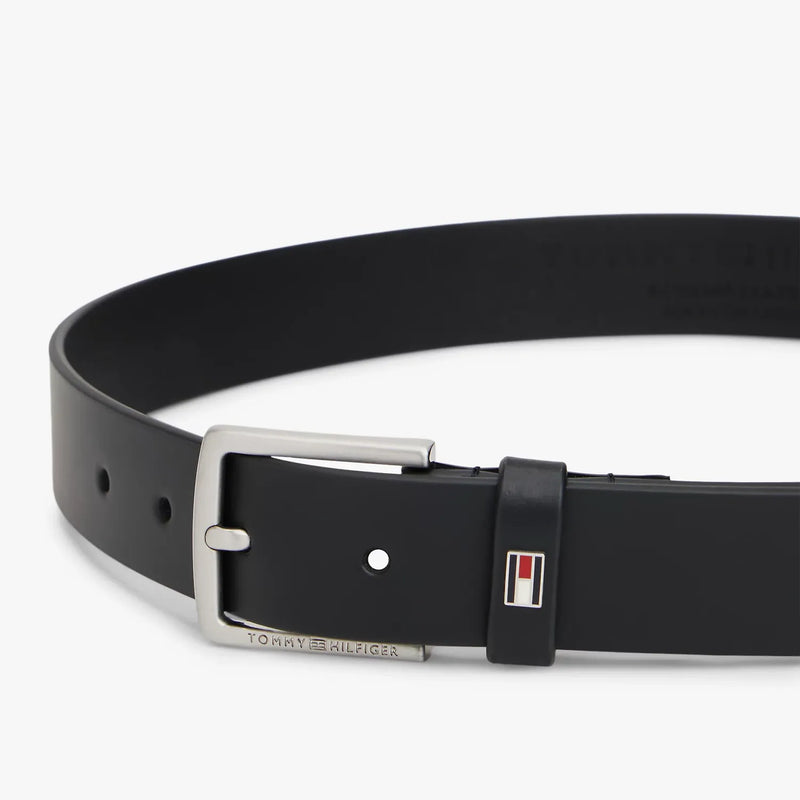Closer look at the Tommy Hilfiger leather belt showing detail of the enamel flag branding.