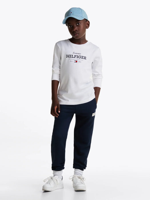 Boy modelling the Tommy Hilfiger long sleeve 1985 t-shirt.