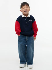 Smiling Boy modelling the Tommy Hilfiger long sleeve rugby shirt.
