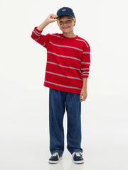 Smiling Boy modelling the Tommy Hilfiger long sleeve striped t-shirt.