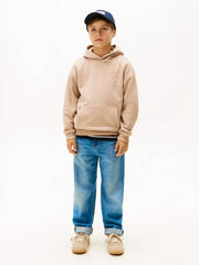 Boy wearing the Tommy Hilfiger mini logo hoodie.