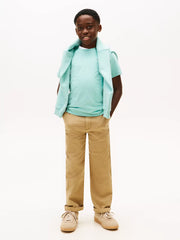 Boy in green mini logo t-shirt by Tommy Hilfiger.