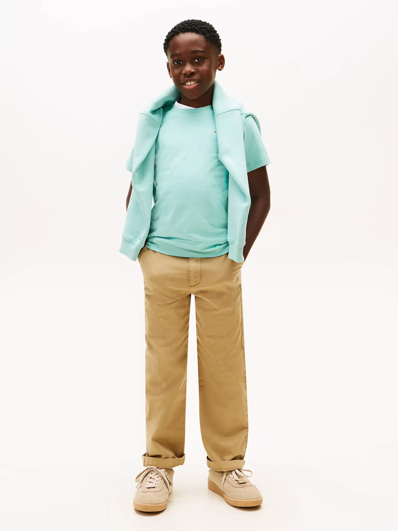 Boy in green mini logo t-shirt by Tommy Hilfiger.