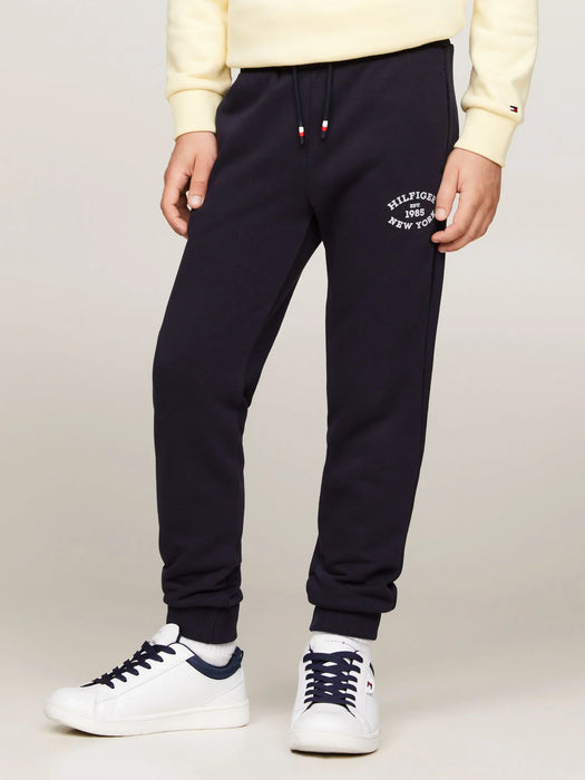 Boy wearing the Tommy Hilfiger monotype track bottoms.