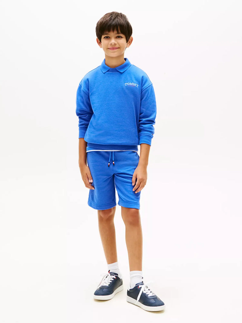 Boy modelling the Tommy Hilfiger monotype track shorts.