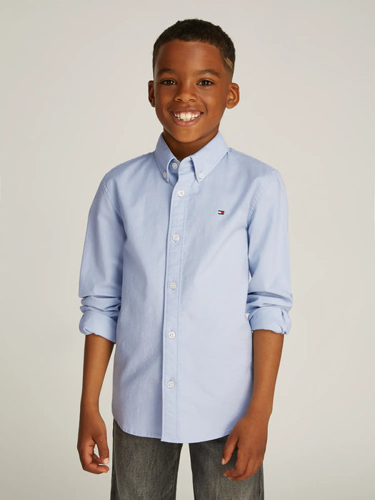 Boy modelling the Tommy Hilfiger oxford shirt.