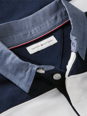 Closer look at the Tommy Hilfiger rugby shirt showing detail of the contrasting grey collar.