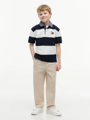 Boy in navy rugby shirt by Tommy Hilfiger.