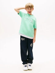 Boy wearing the Tommy Hilfiger script logo t-shirt.