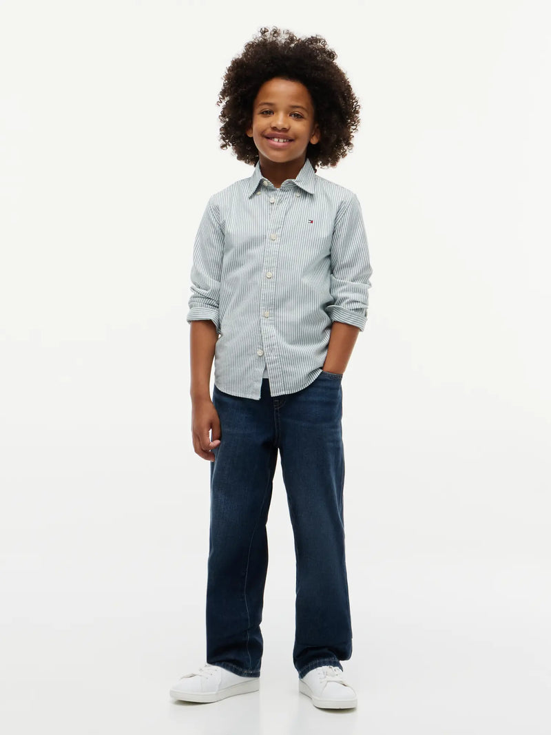 Boy modelling the Tommy Hilfiger striped oxford shirt.