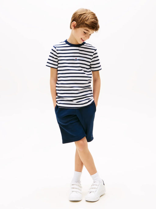 Smiling boy modelling the Tommy Hilfiger striped shorts set.