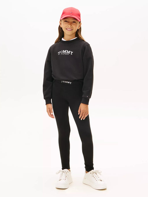 Girl modelling the Tommy Hilfiger sweatshirt & leggings.