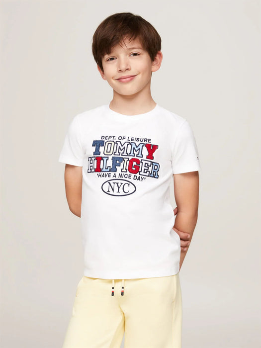 Boy wearing the Tommy Hilfiger nyc logo t-shirt.