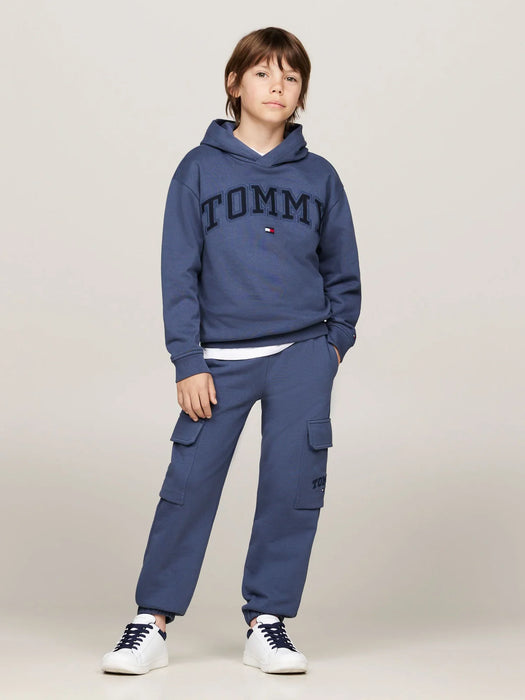 Boy wearing the Tommy Hilfiger varsity hoodie.