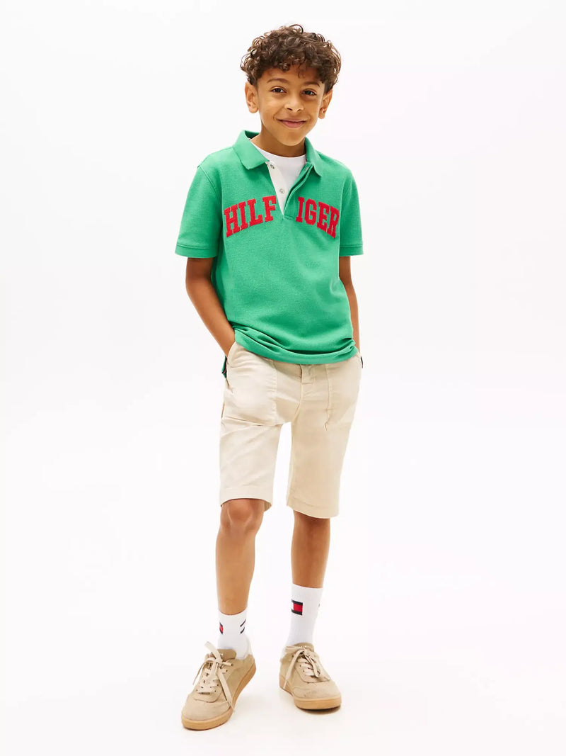 Boy modelling the Tommy Hilfiger varsity polo shirt.