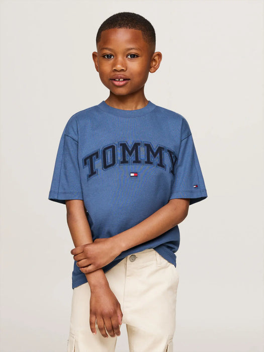 Boy wearing the Tommy Hilfiger varsity t-shirt.