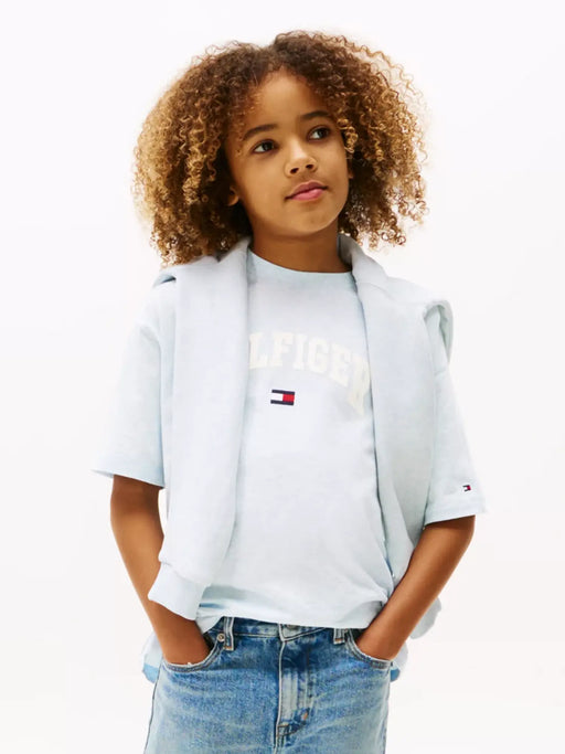 Boy wearing the Tommy Hilfiger varsity t-shirt.