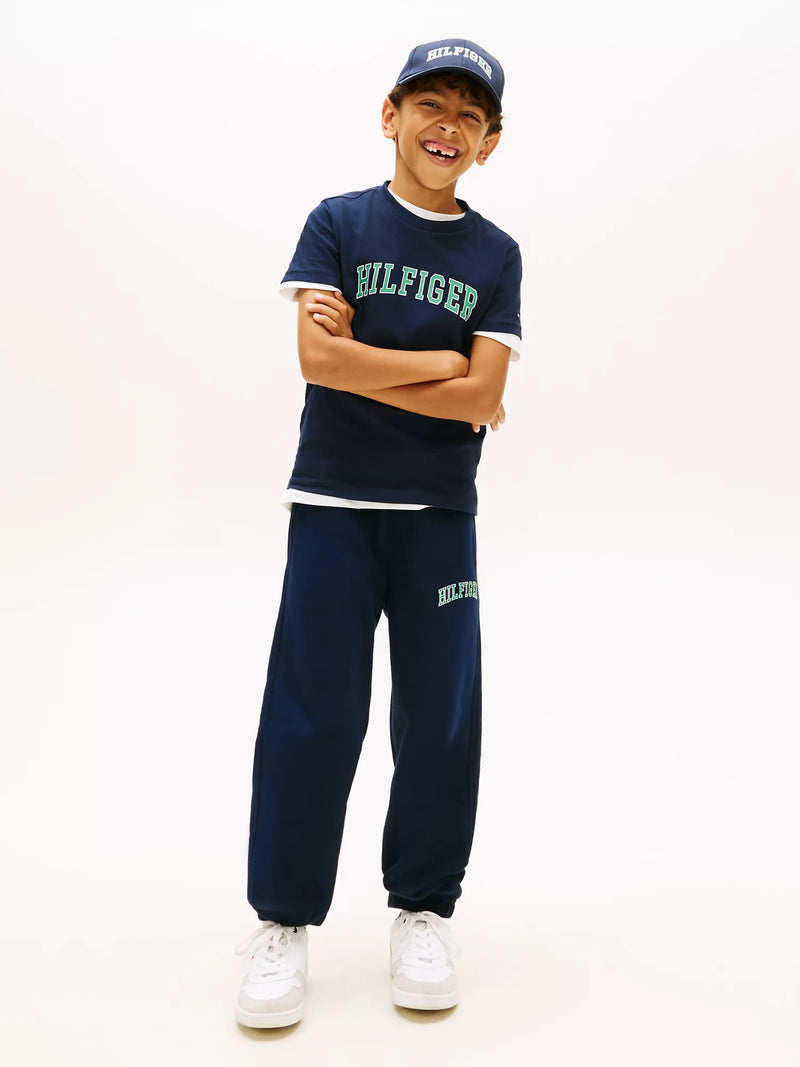 Boy modelling the Tommy Hilfiger varsity t-shirt.