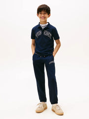 Boy wearing the Tommy Hilfiger varsity track bottoms.