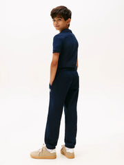 Rear view of the Tommy Hilfiger navy varsity track bottoms.