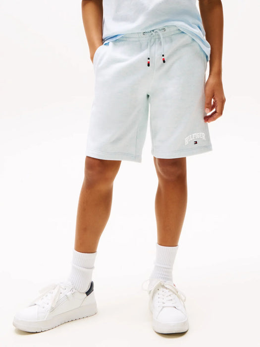 Boy wearing the Tommy Hilfiger varsity track shorts.