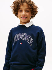 Boy modelling the Tommy Hilfiger varsity tracksuit.