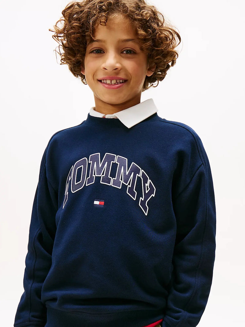 Boy modelling the Tommy Hilfiger varsity tracksuit.