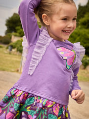 Smiling Girl modelling the Tuc Tuc butterfly dress.
